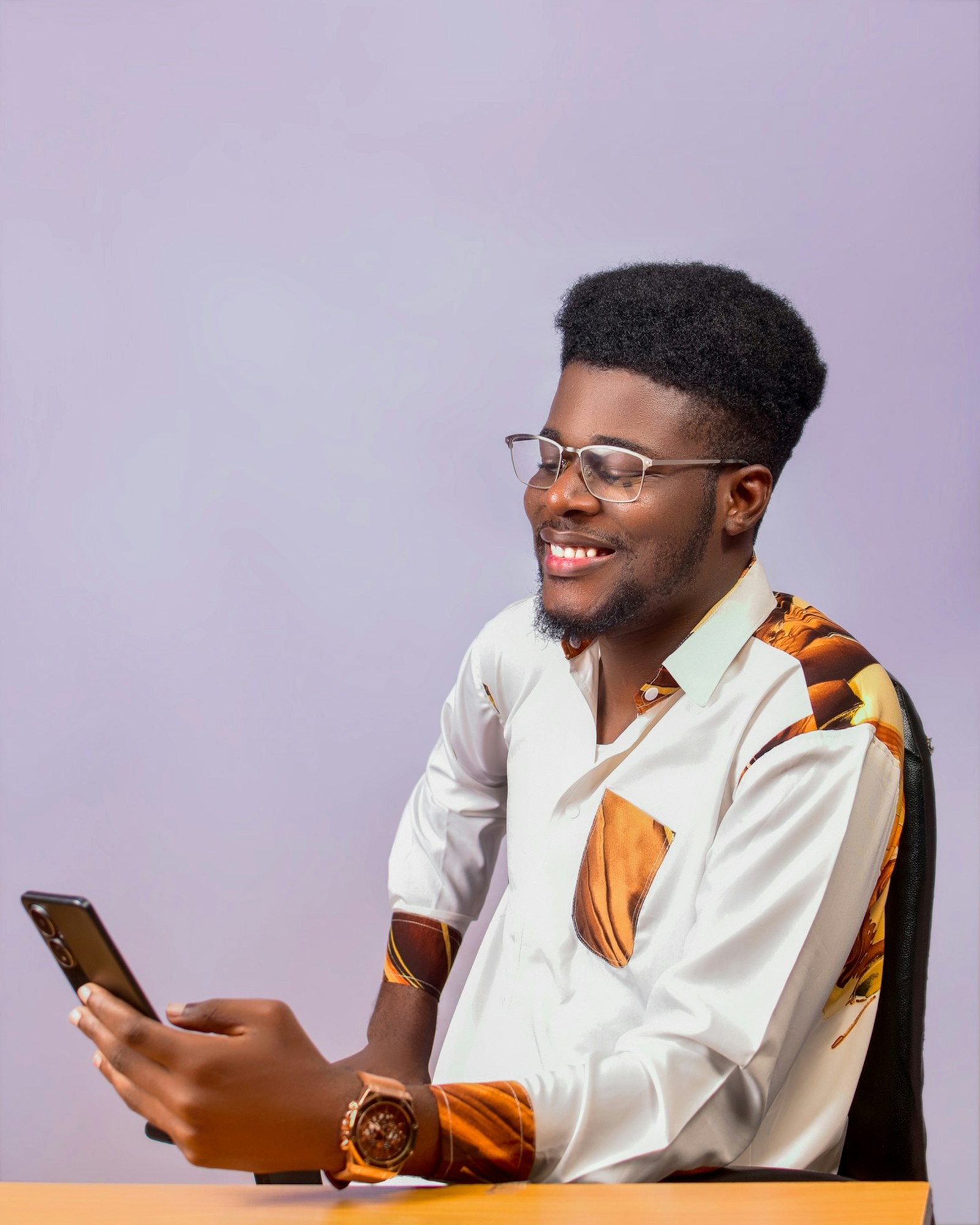 A young Nigerian professional reviewing a banking app on a phone