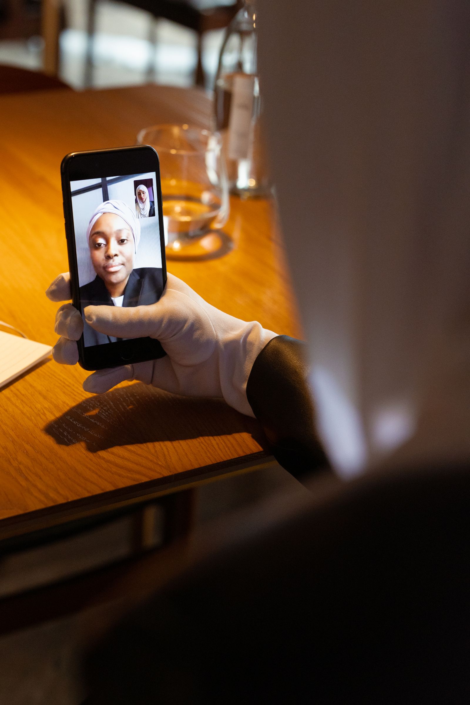 A woman on a video call on her smartphone at a table